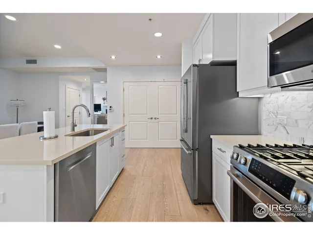 a kitchen with refrigerator a stove and a sink