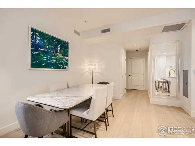 a view of a dining room with furniture and a large window