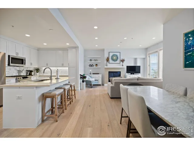 a kitchen with cabinets and chairs