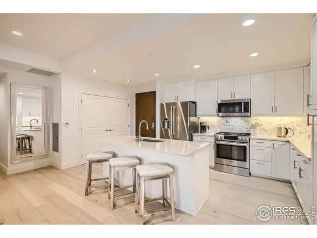 a kitchen with granite countertop a stove top oven and cabinets