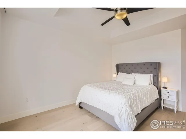 a bedroom with a bed and a ceiling fan