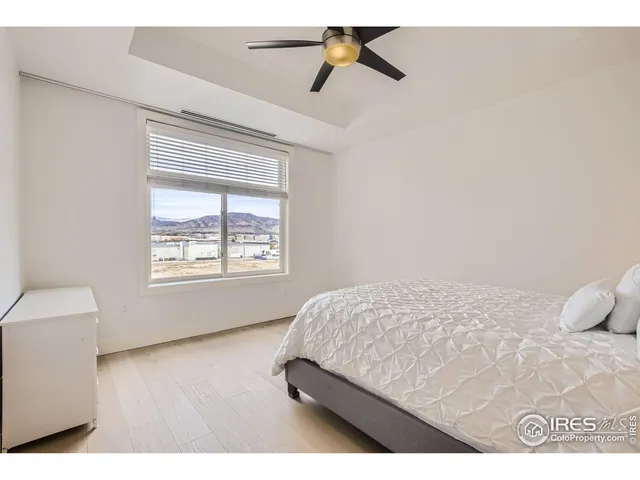 a bedroom with a bed a window and couch