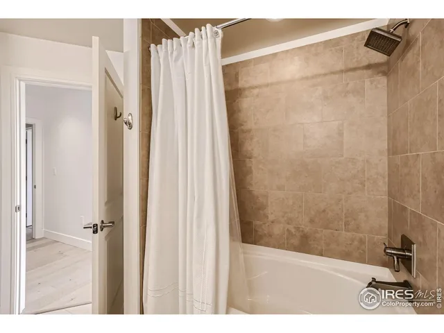 a bathroom with a shower and a sink