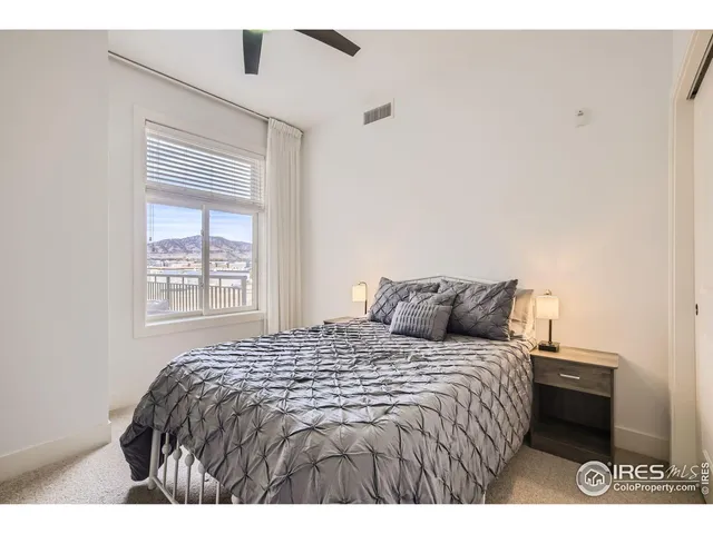 a bed sitting in a bedroom next to a window