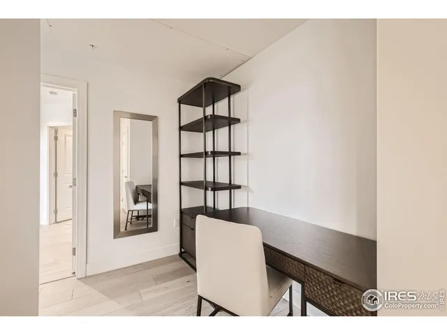 a view of workspace filled with furniture and window