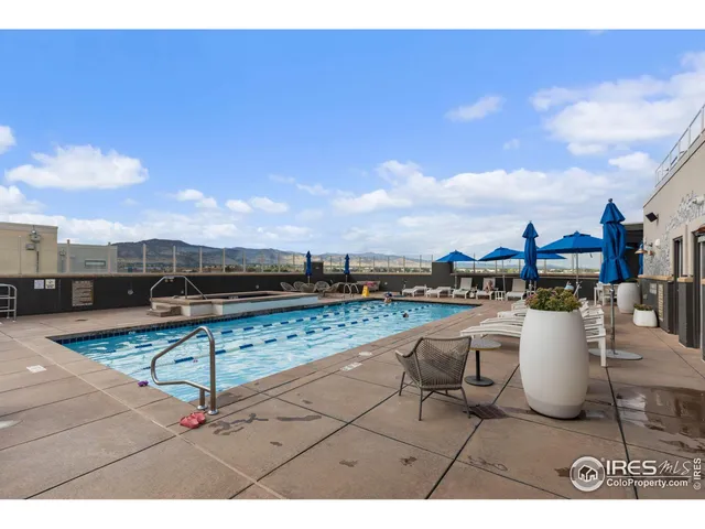 a roof deck with table and chairs