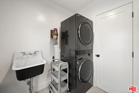 a utility room with sink dryer and washer