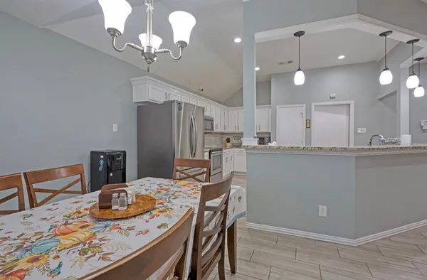 a kitchen with stainless steel appliances granite countertop a sink a refrigerator and a stove