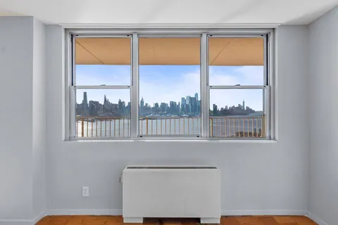 a view of a room that has a bed and a window