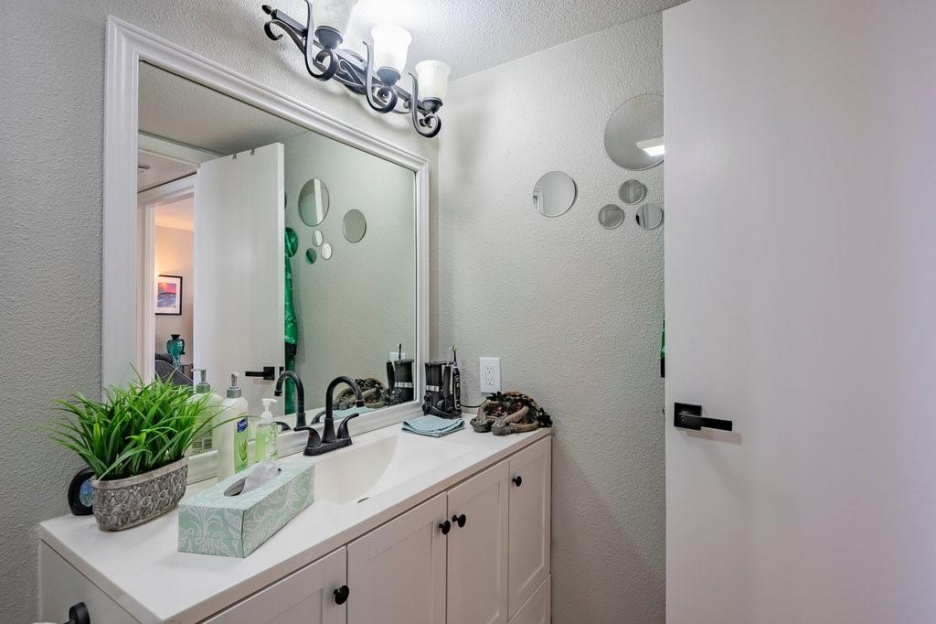 5000 Bowser Avenue, Unit 211 Dallas, TX 75209 - Photo 11 of 17 a bathroom with a sink a mirror and a shower