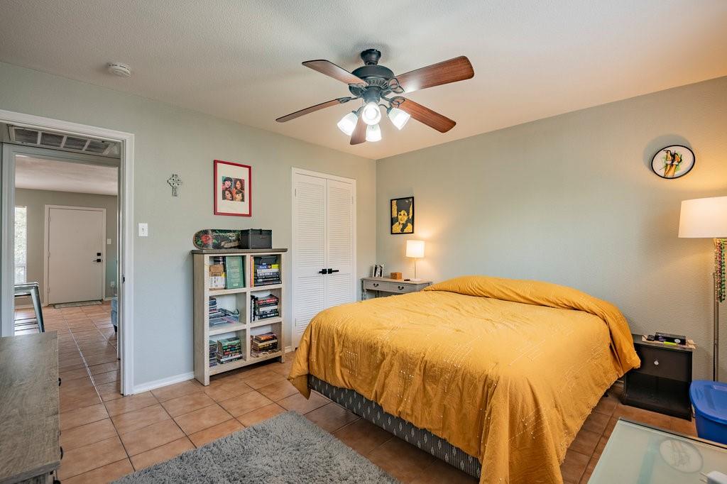 5000 Bowser Avenue, Unit 211 Dallas, TX 75209 - Photo 13 of 17 a bedroom with a bed and a chandelier