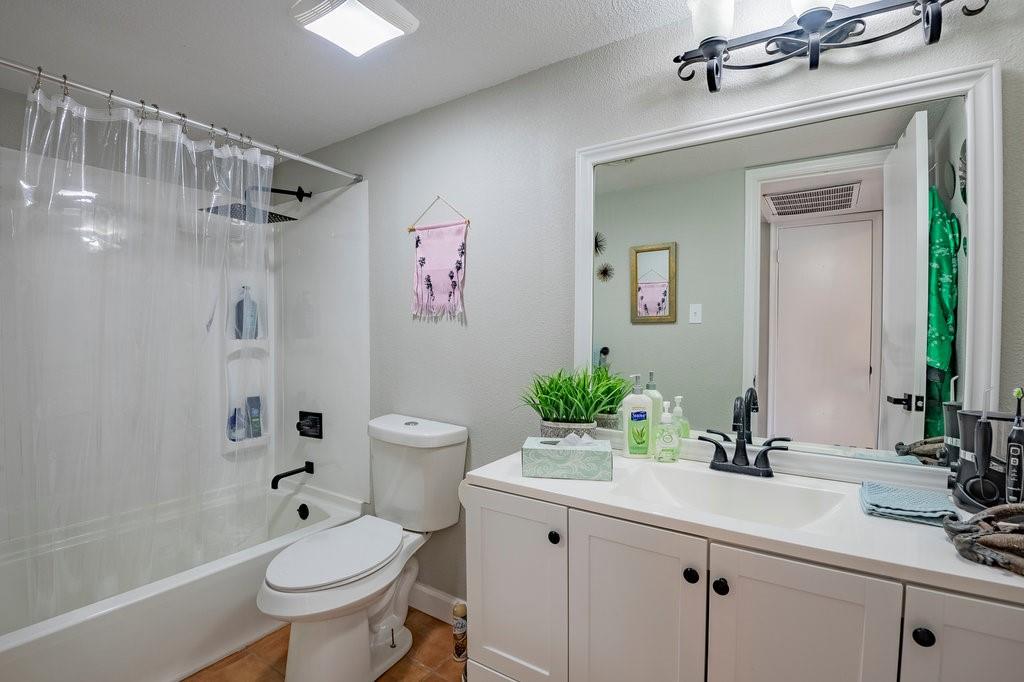 5000 Bowser Avenue, Unit 211 Dallas, TX 75209 - Photo 10 of 17 a bathroom with a sink toilet a mirror a vanity and shower