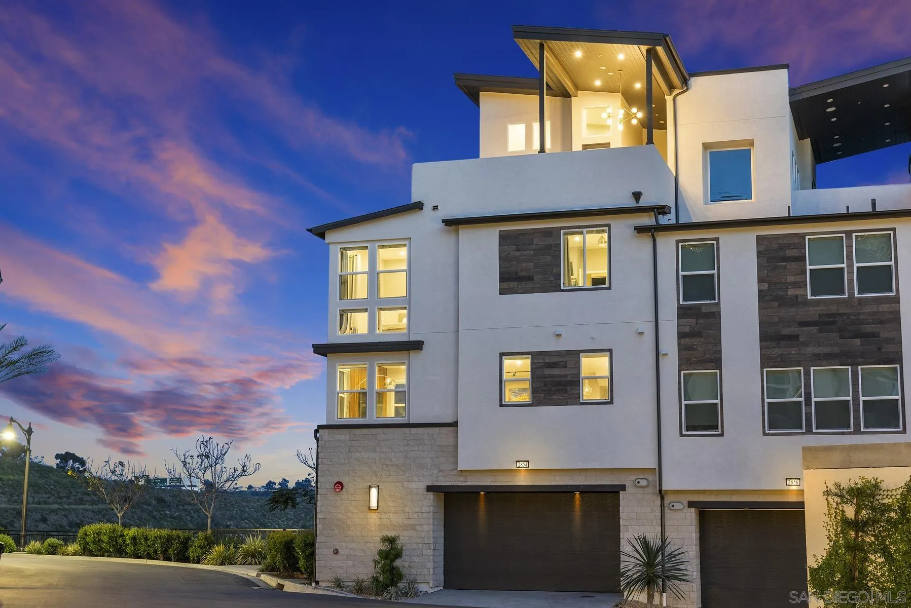 a front view of a residential apartment building with a yard