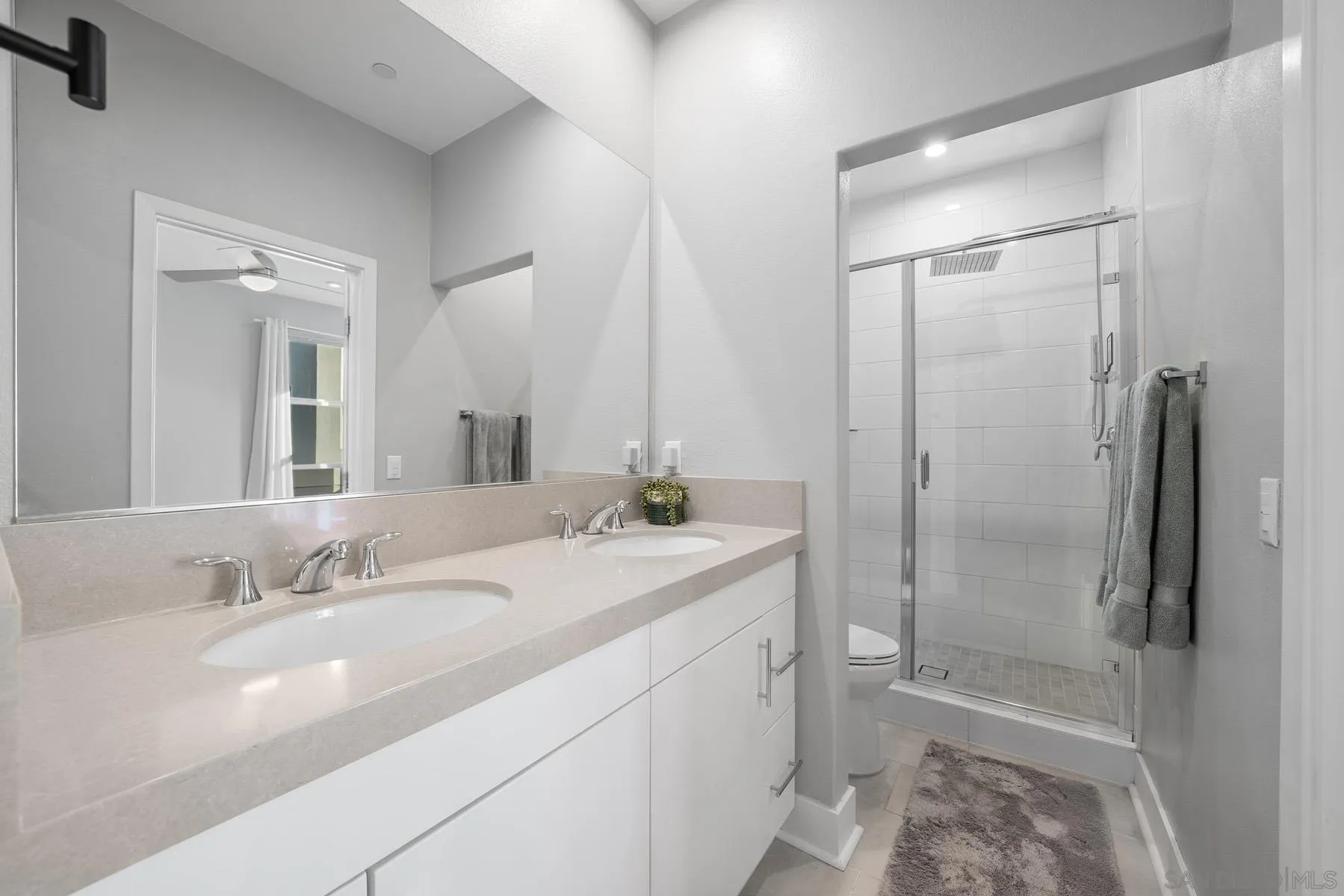 2854 Avella Circle San Diego, CA 92108 - Photo 14 of 31 a bathroom with a shower sink vanity and mirror