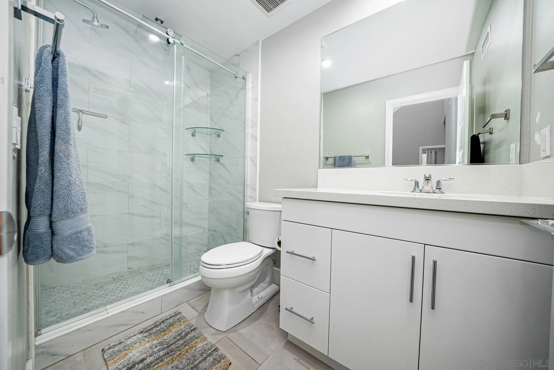 2854 Avella Circle San Diego, CA 92108 - Photo 17 of 31 a bathroom with a sink toilet a mirror and shower