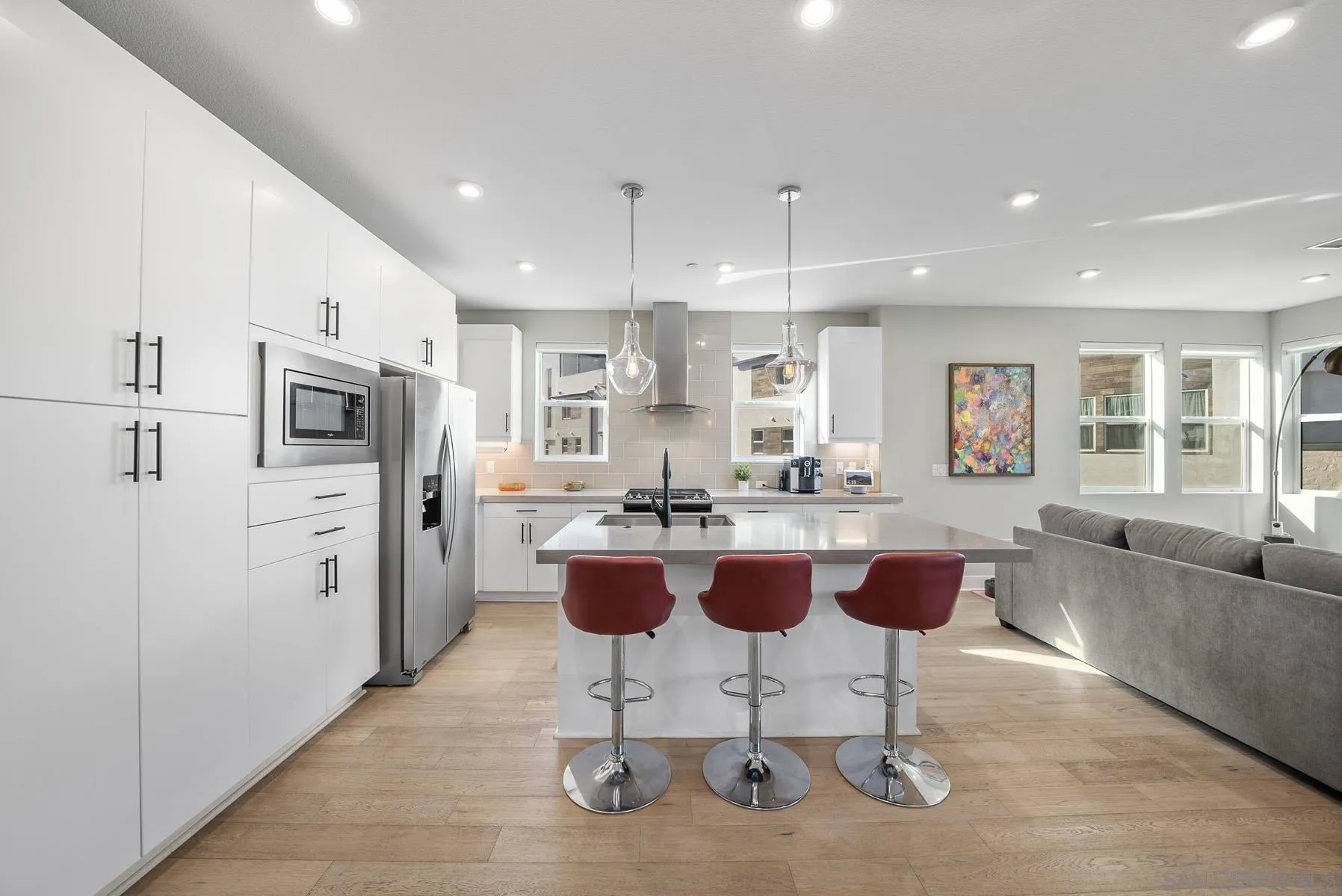 2854 Avella Circle San Diego, CA 92108 - Photo 6 of 31 a kitchen with stainless steel appliances kitchen island granite countertop a refrigerator a stove a sink a dining table and chairs