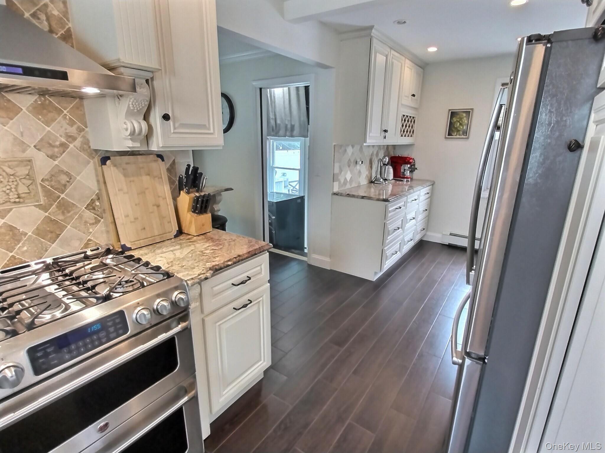 3037 Morrow Road Oceanside, NY 11572 - Photo 12 of 38 a kitchen with stainless steel appliances a stove a refrigerator and cabinets