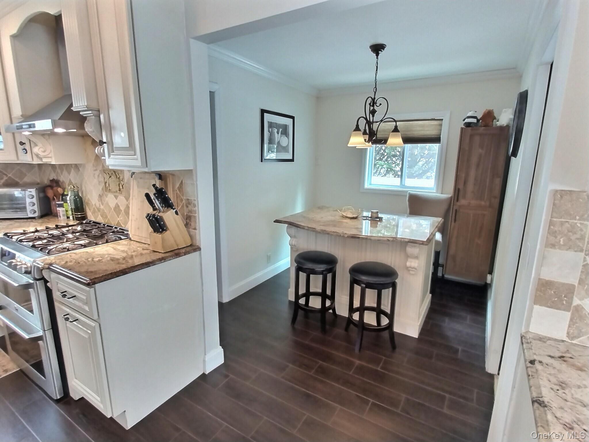 3037 Morrow Road Oceanside, NY 11572 - Photo 15 of 38 a kitchen with sink refrigerator dining table and chairs