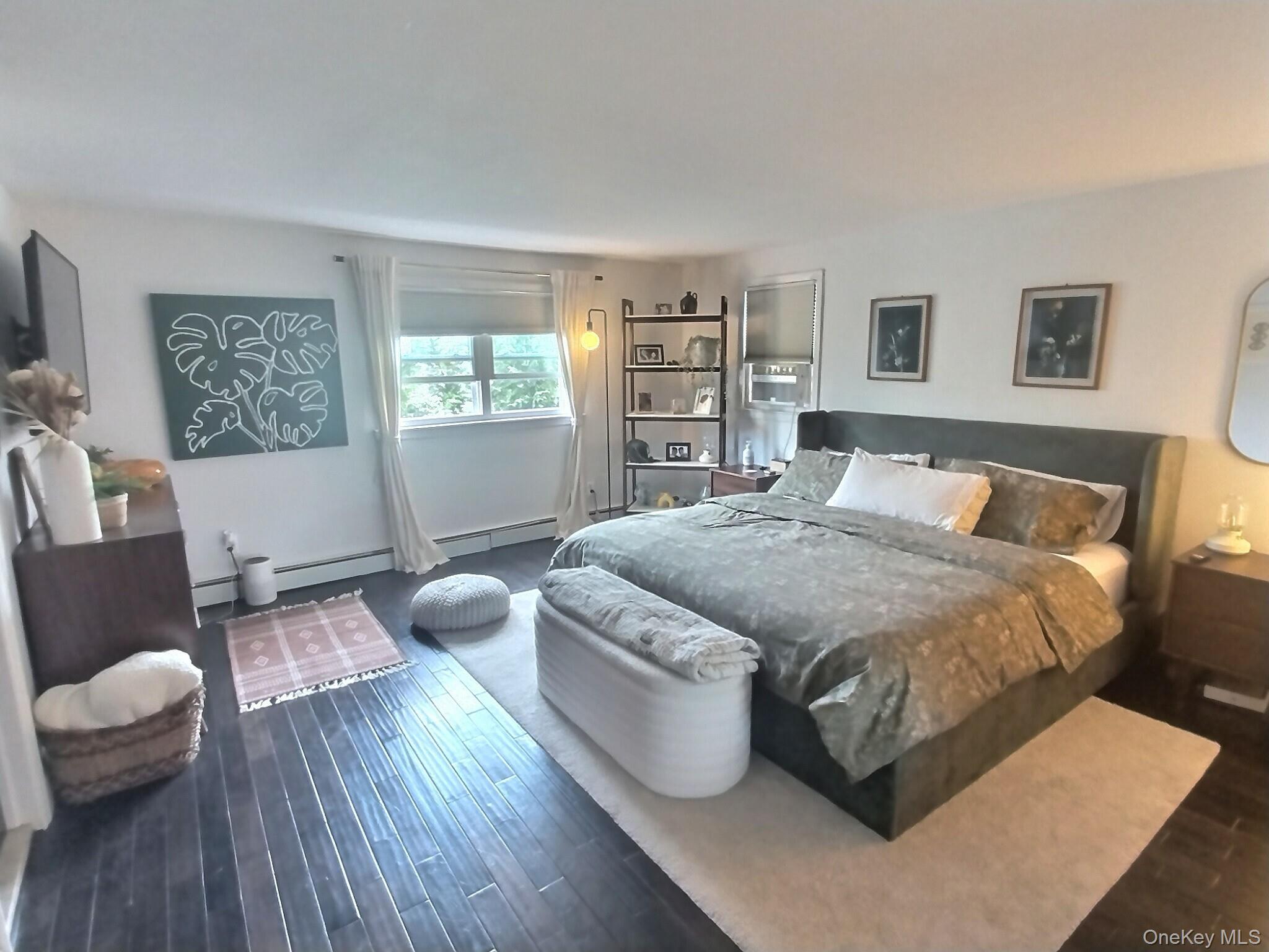 3037 Morrow Road Oceanside, NY 11572 - Photo 24 of 38 a spacious bedroom with a bed and wooden floor