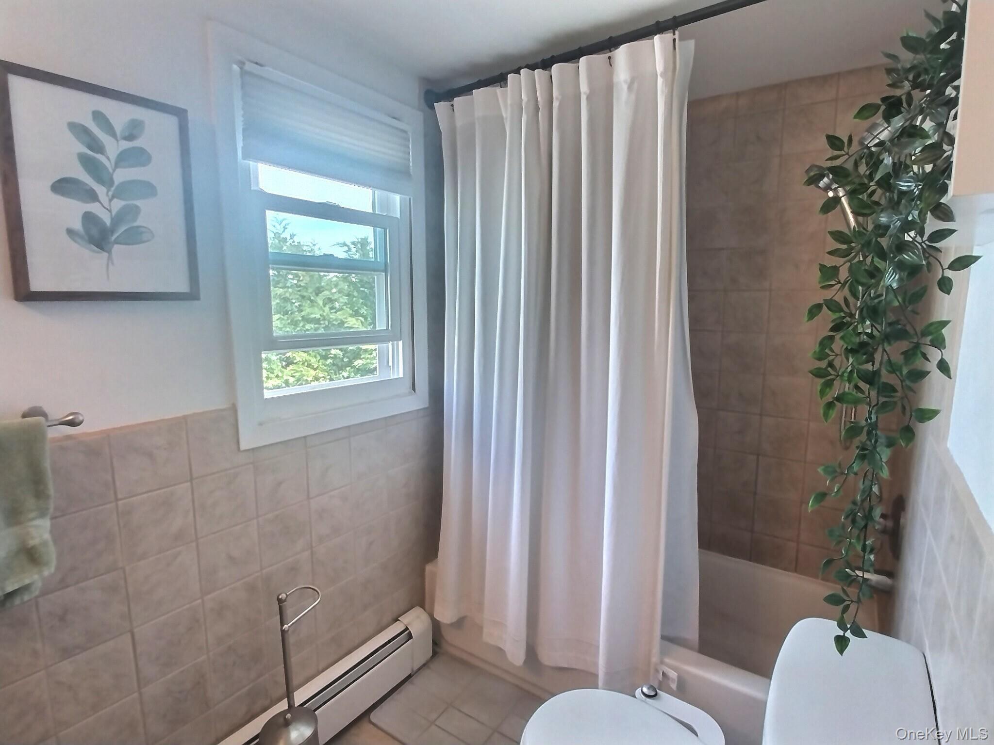 3037 Morrow Road Oceanside, NY 11572 - Photo 28 of 38 a bathroom with a toilet and a shower