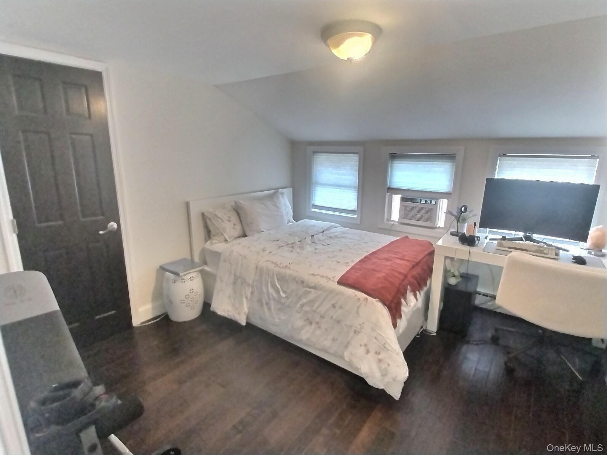 3037 Morrow Road Oceanside, NY 11572 - Photo 31 of 38 a bedroom with a bed and wooden floor