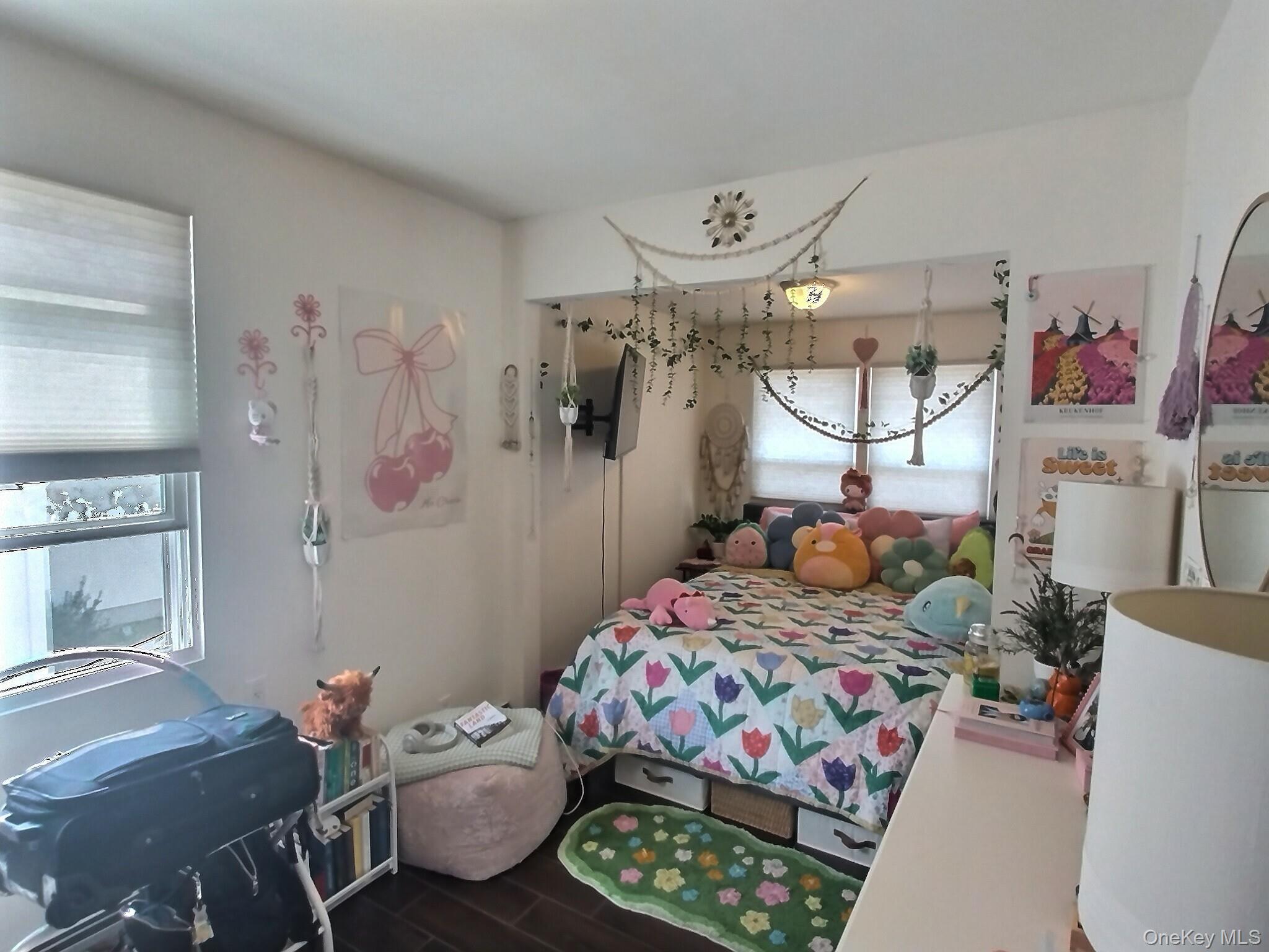 3037 Morrow Road Oceanside, NY 11572 - Photo 33 of 38 a bedroom with a bed and a chandelier