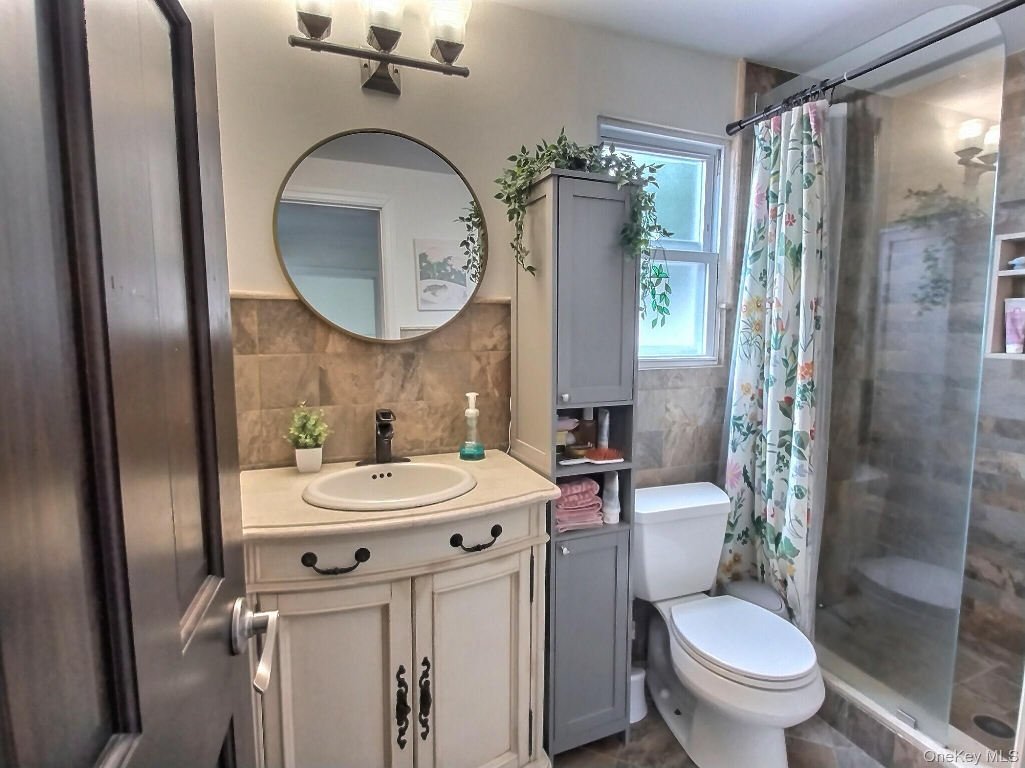 3037 Morrow Road Oceanside, NY 11572 - Photo 34 of 38 a bathroom with a sink toilet and shower