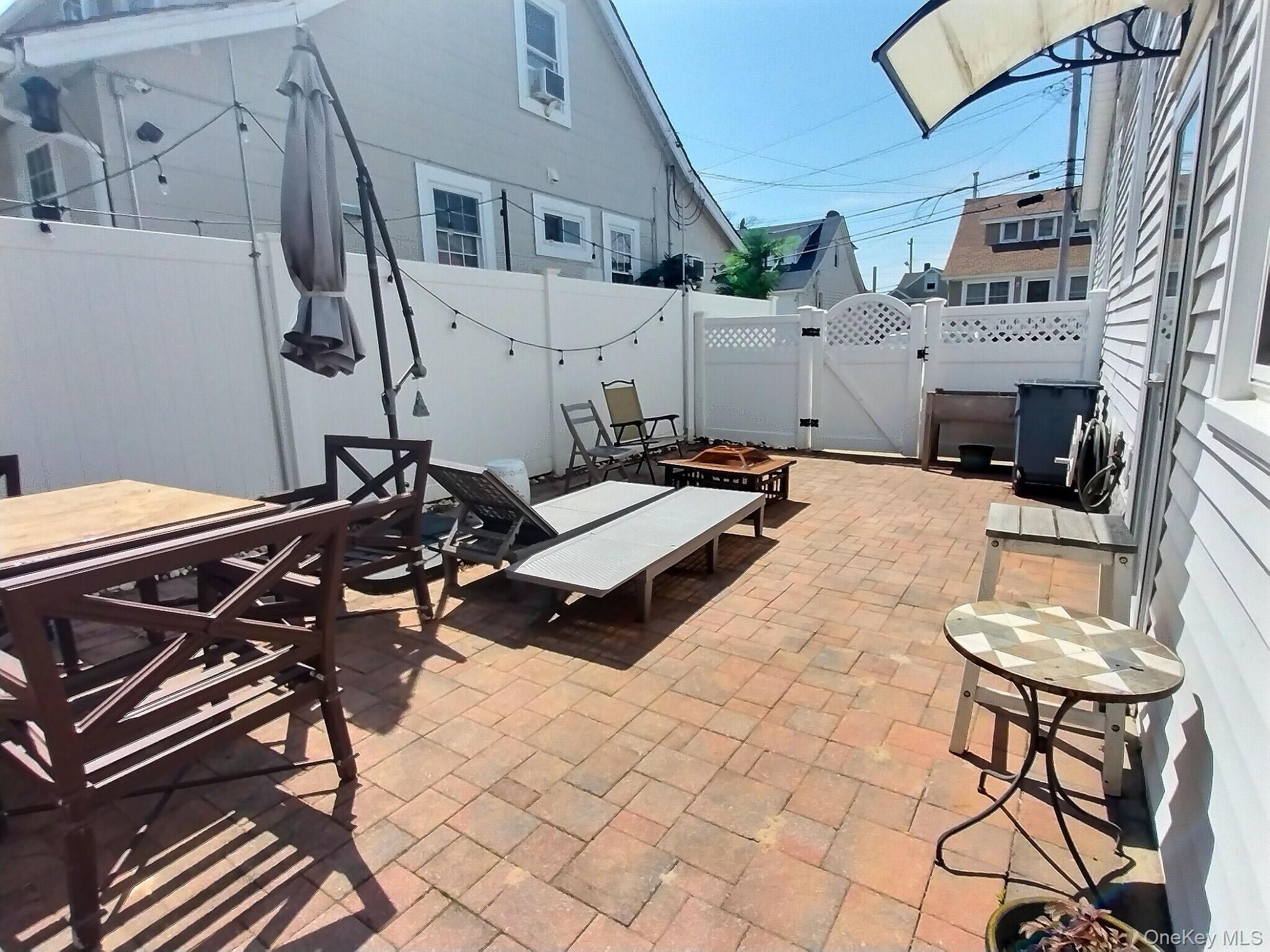 3037 Morrow Road Oceanside, NY 11572 - Photo 36 of 38 a backyard of a house with table and chairs