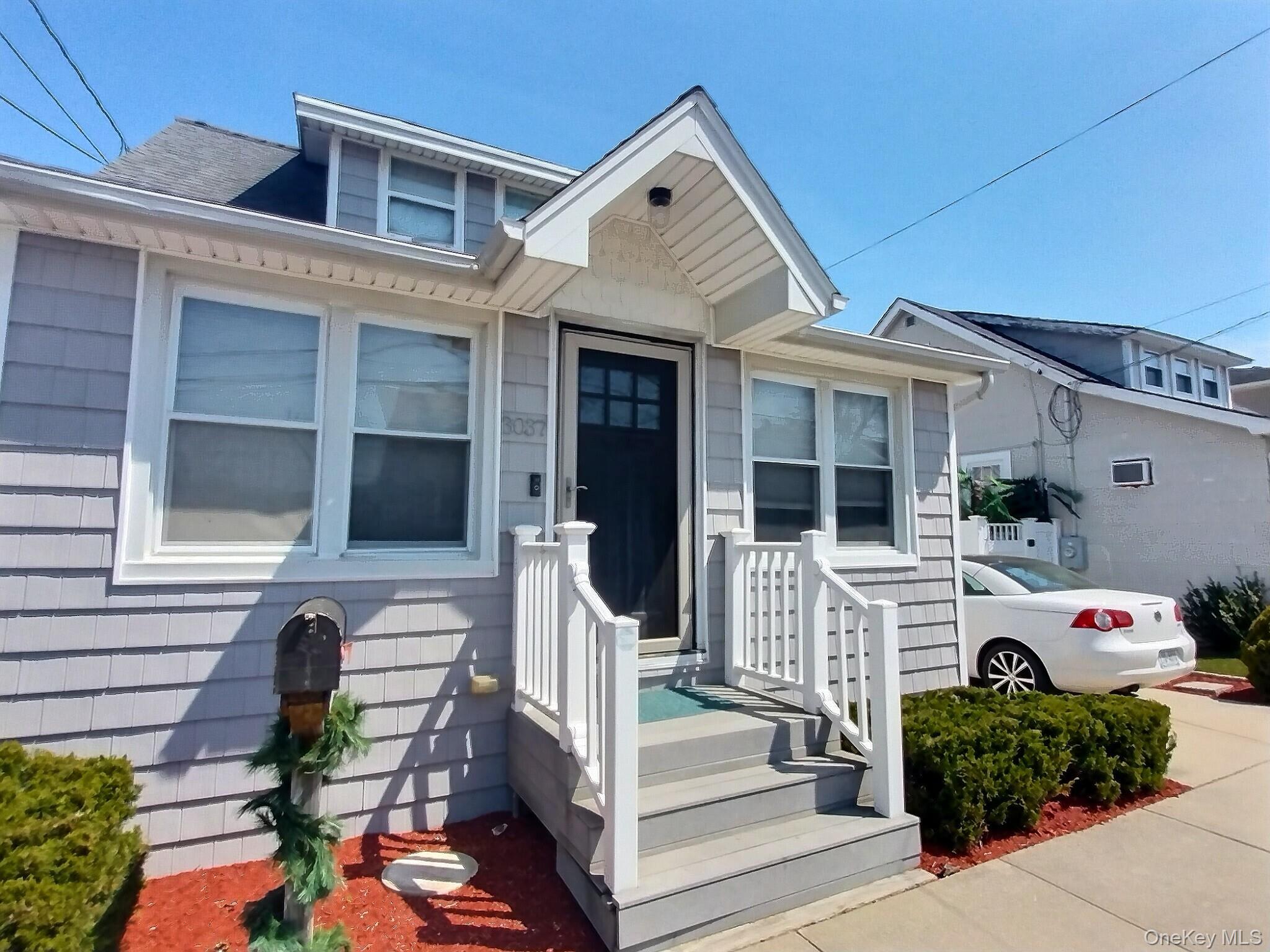 3037 Morrow Road Oceanside, NY 11572 - Photo 5 of 38 a front view of a house with a porch