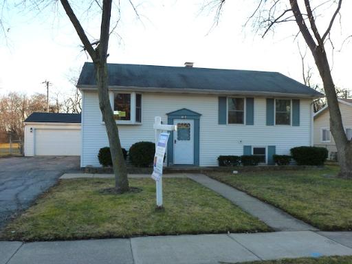 612 Springbrook Drive Aurora, IL 60506 - Photo 1 of 7 a front view of house with yard