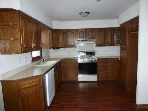 612 Springbrook Drive Aurora, IL 60506 - Photo 2 of 7 a kitchen with a sink a stove and cabinets