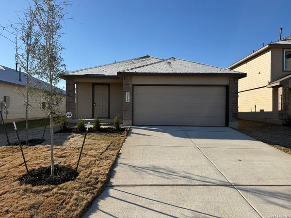 a view of a house with a small yard and plants