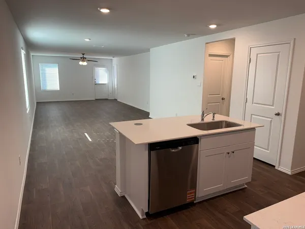 a kitchen with sink and cabinets