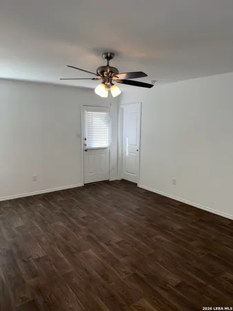 a view of a livingroom with a ceiling fan window and a ceiling fan