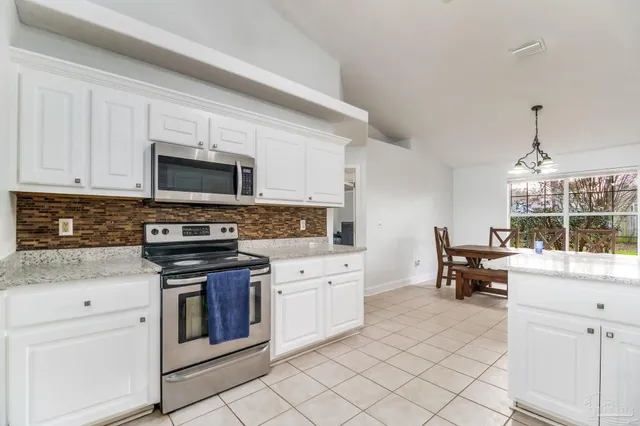 a kitchen with cabinets appliances and a counter top space