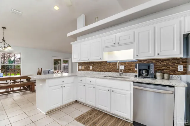 a kitchen with stainless steel appliances granite countertop a sink and cabinets