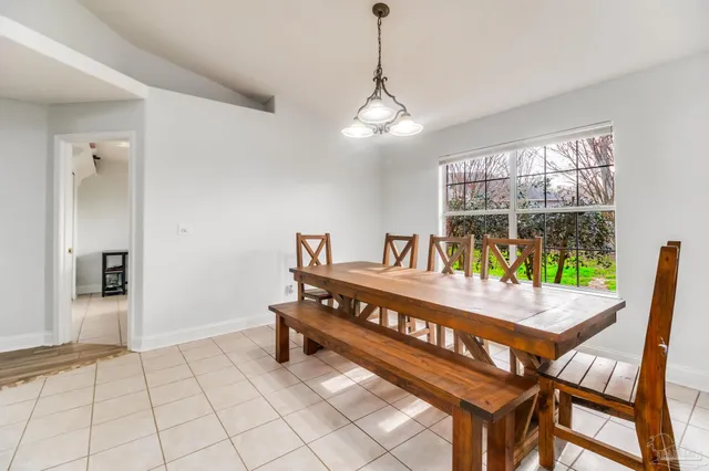 a dining room with furniture and window