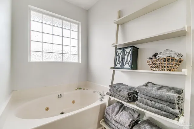 a bathroom with a walk in closet and a bathroom