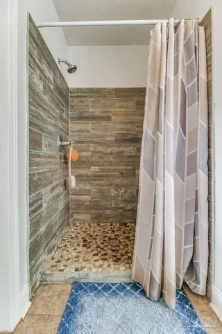 a view of walk in closet with clothes