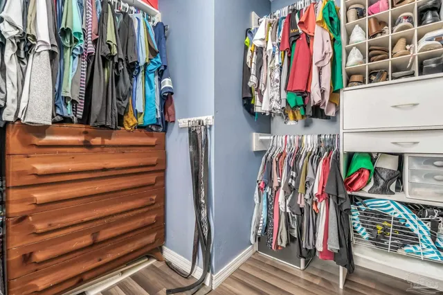 a view of walk in closet with clothes