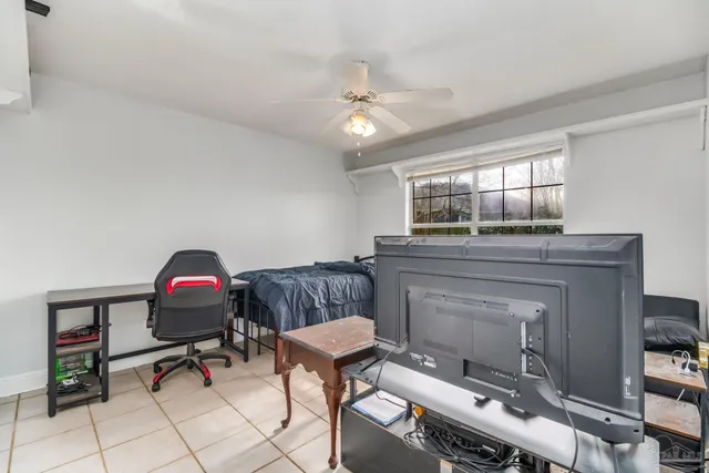 a living room with a large window and a chandelier
