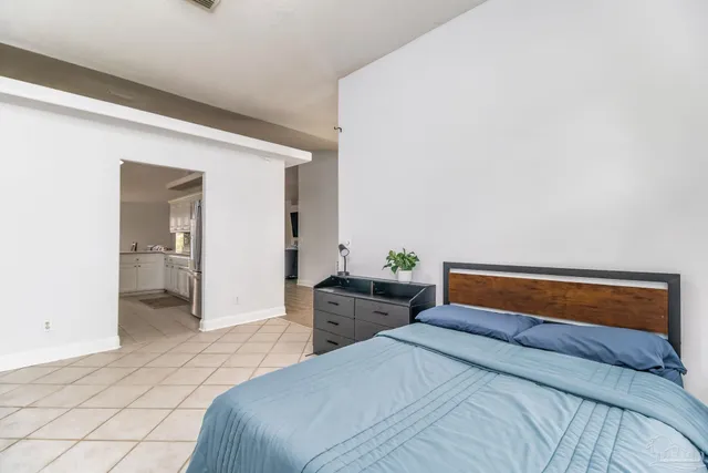 a view of a patio with a table and chairs and floor to ceiling window