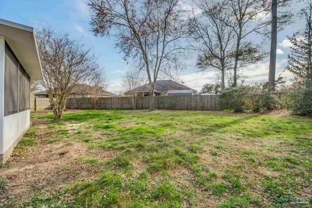 a view of a house with a yard and sitting area