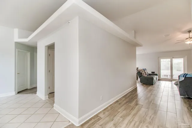 a bedroom with furniture and a large window