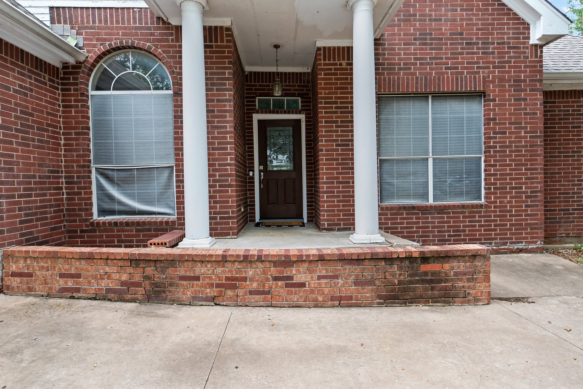 11737 Rydalwater Lane Austin, TX 78754 - Photo 3 of 40 Brick facade with a covered porch featuring two white columns