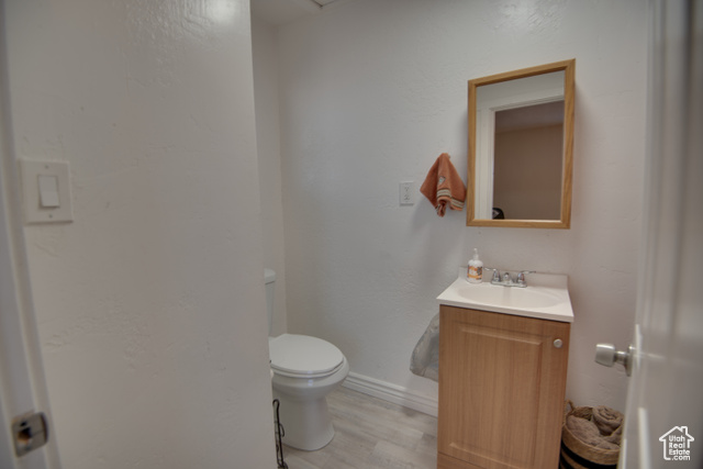 410 North Main Street Beaver, UT 84713 - Photo 6 of 31 Bathroom featuring hardwood / wood-style flooring, vanity, and toilet