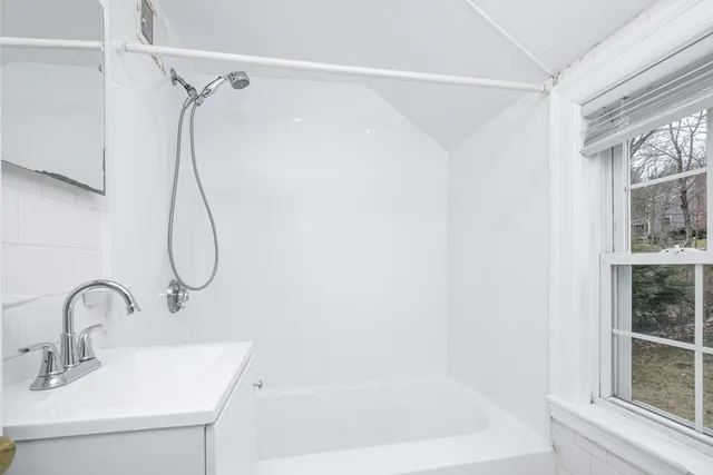 a bathroom with a sink and a window