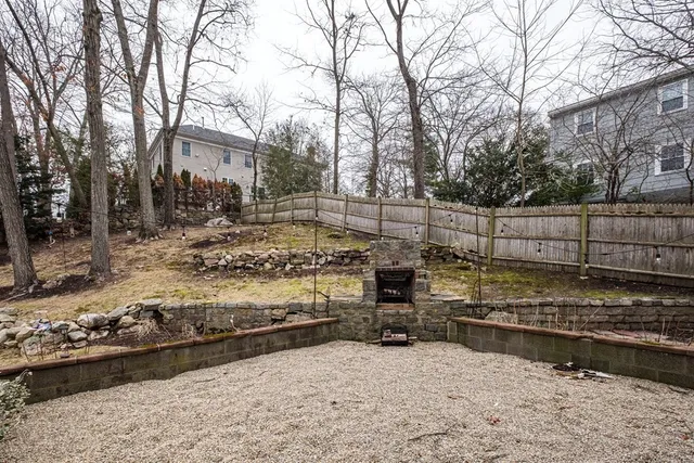 a view of a yard with wooden fence