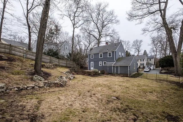a view of a house with a yard covered in snow