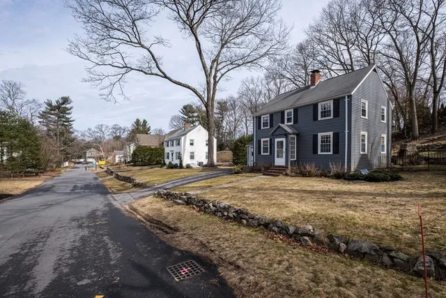 a view of large house with a yard covered in snow
